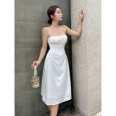 Silk midi dress with ruched bust and adjustable straps, featuring a sleek fitted silhouette